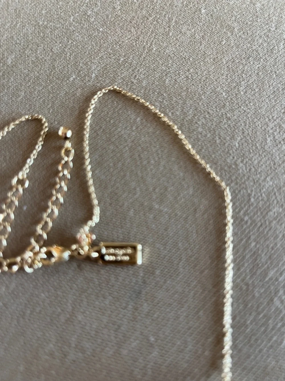 Kate Spade long golden necklace with crystal beads.